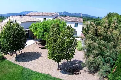 an aerial view of a house with trees in front at Mas des Grialou, grand mas provencal de standing in Carpentras