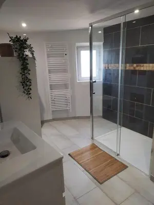 a bathroom with a shower with a glass door at Maison dans le luberon in Viens