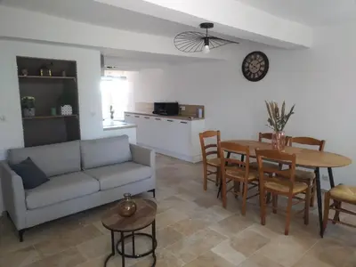a living room with a couch and a table at Maison dans le luberon in Viens