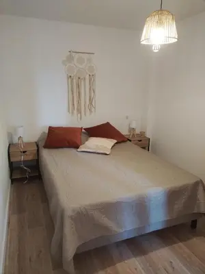 a bedroom with a large bed with two night stands at Maison dans le luberon in Viens