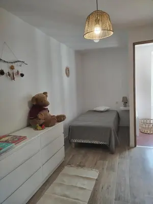 a teddy bear sitting on a dresser in a bedroom at Maison dans le luberon in Viens