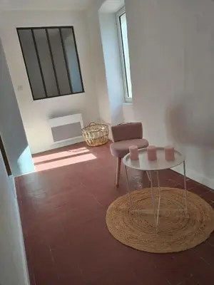 a living room with a table and a chair at Maison dans le luberon in Viens