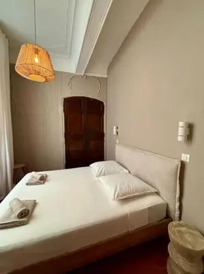 a bedroom with a large white bed with a lamp at Splendide T2 au coeur d'Aix et du Cours Mirabeau in Aix-en-Provence
