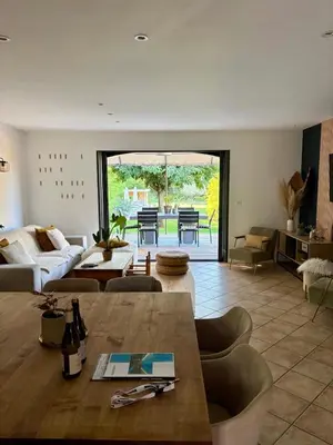 a living room with a couch and a table at Maison avec piscine au calme au pied du Ventoux in Mazan