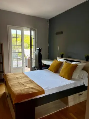 a bedroom with a large bed with yellow pillows at Maison avec piscine au calme au pied du Ventoux in Mazan