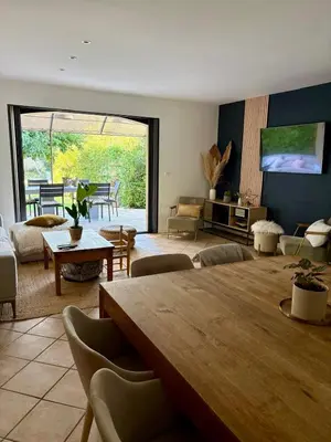 a large living room with a large wooden table at Maison avec piscine au calme au pied du Ventoux in Mazan