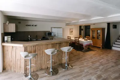 a kitchen with a counter and stools in a room at 