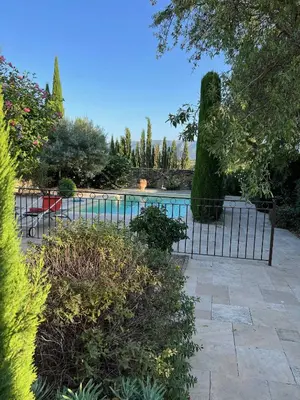 a fence in front of a swimming pool at Clos de l'Abba in Gordes