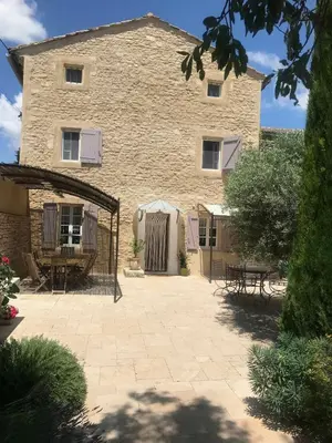 a large stone building with a patio in front of it at Clos de l'Abba in Gordes