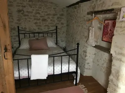 a bedroom with a bed in a room with brick walls at Clos de l'Abba in Gordes