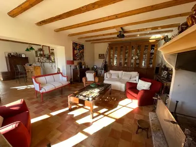 a living room with couches and a table at Mas Chamsomat in Robion en Luberon
