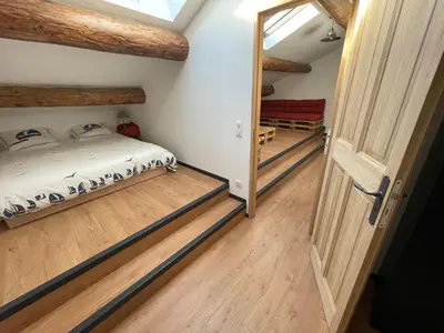 a room with a bed and an open door at Mas Chamsomat in Robion en Luberon