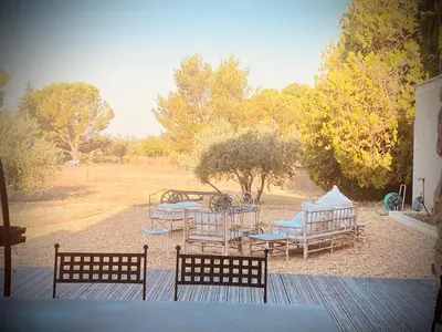 a group of chairs and tables on a deck at Mas Chamsomat in Robion en Luberon
