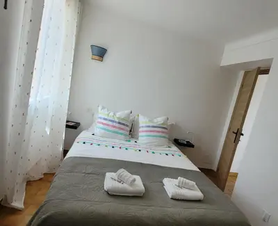 a bedroom with a bed with two towels on it at Le jardin des oliviers in Apt