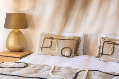 a bedroom with a bed with pillows and a lamp at Vue Dexception Gordes in Gordes
