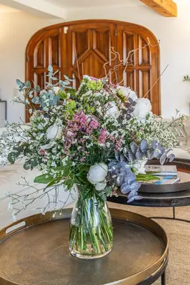 a vase filled with flowers on a table at Vue Dexception Gordes in Gordes