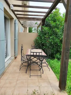 a table and chairs sitting on a patio at La provençale in Saint-Saturnin-lès-Avignon