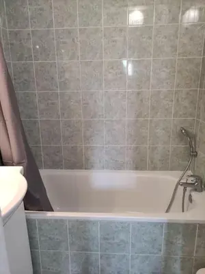 a bathroom with a bath tub with a sink at La provençale in Saint-Saturnin-lès-Avignon