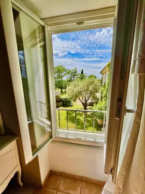 a window in a room with a view of a tree at Domaine de Canfier, maison d'hôtes in Robion en Luberon