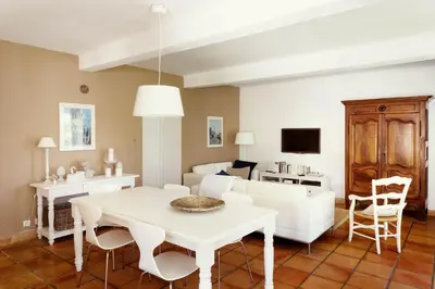 a living room with a white table and a white couch at Domaine de Canfier, maison d'hôtes in Robion en Luberon