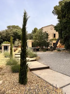 a tree in front of a building with a playground at Villa du Tallagard in Salon-de-Provence