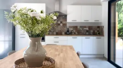 a vase of flowers sitting on a table in a kitchen at Villa du Tallagard in Salon-de-Provence