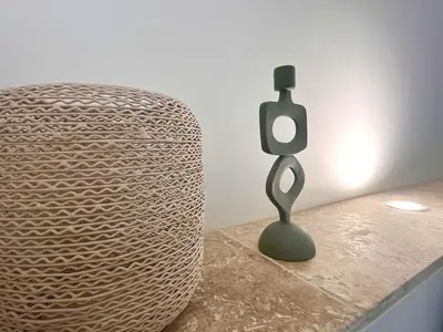 a sculpture sitting on a table next to a chair at Villa du Tallagard in Salon-de-Provence