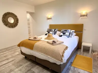 a bedroom with a large bed with hats on it at Villa du Tallagard in Salon-de-Provence