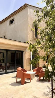 a group of chairs and a table in front of a building at Villa du Tallagard in Salon-de-Provence
