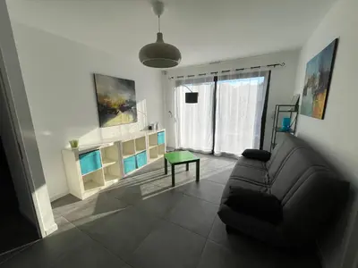 a living room with a couch and a table at Villa Spacieuse avec Piscine in Entraigues-sur-la-Sorgue