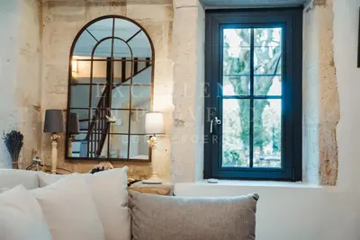 a living room with a couch and a window at Mas de l'air in Noves