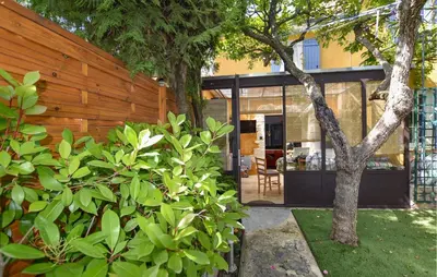 a house with glass doors and trees in a yard at 3 Bedroom Awesome Home In Carpentras in Carpentras