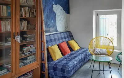 a blue couch with colorful pillows in a room at 3 Bedroom Awesome Home In Carpentras in Carpentras
