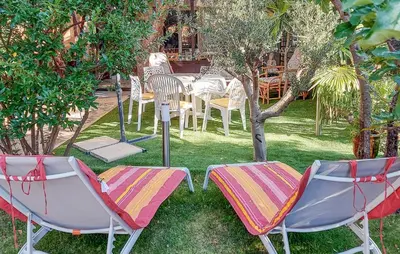 a group of chairs and a table in a yard at 3 Bedroom Awesome Home In Carpentras in Carpentras