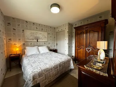 a bedroom with a bed and a table with a lamp at Le refuge des oiseaux in Lourmarin