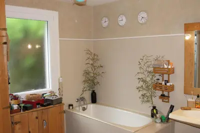 a bathroom with a tub and a window and a sink at Maison provençale avec piscine in Loriol-du-Comtat