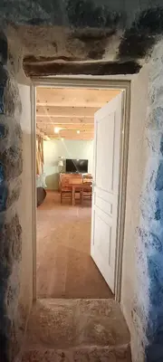 an open door into a room with a living room at JAS provençal pour 6 personnes à 2mn de la Grange de Javon in Monieux