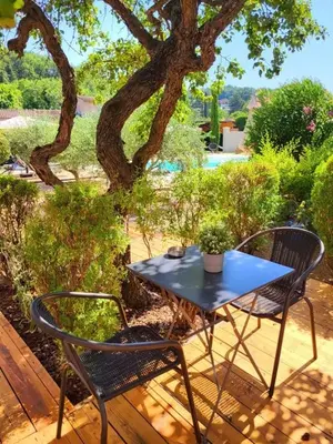 a blue table and two chairs sitting on a deck at Le Cabanon de Marie in Saignon