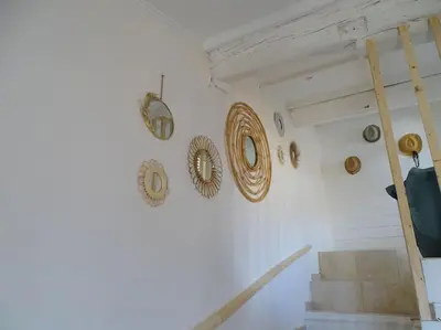 a room with a staircase with a bunch of mirrors on the wall at Maison avec terrasse panoramique in Châteauneuf-de-Gadagne