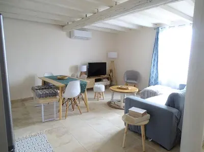 a living room with a couch and a table at Maison avec terrasse panoramique in Châteauneuf-de-Gadagne