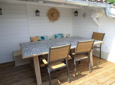 a table and chairs sitting on a patio at Maison avec terrasse panoramique in Châteauneuf-de-Gadagne