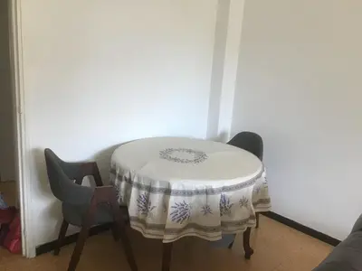 a table with a table cloth on it with two chairs at Ayoug Chambre Individuelle Chez Habitat in Carpentras