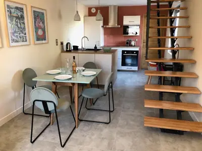 a kitchen and dining room with a table and chairs at L'Oustalet des Alpilles in Saint-Rémy-de-Provence