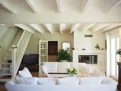 a living room with a white couch and stairs at Holiday Home in Villes-sur-Auzon with Pool in Villes-sur-Auzon