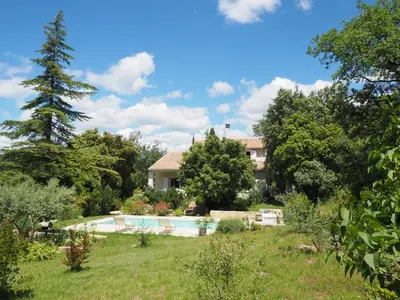 a house with a swimming pool in a garden at Holiday Home in Villes-sur-Auzon with Pool in Villes-sur-Auzon