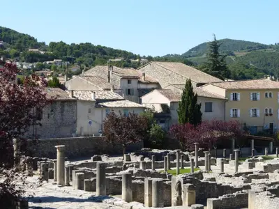 a cluster of ruins in a town with houses at Holiday Home in Villes-sur-Auzon with Pool in Villes-sur-Auzon