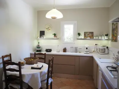 a kitchen with a table and a counter top at Holiday Home in Villes-sur-Auzon with Pool in Villes-sur-Auzon