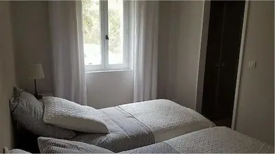 a bedroom with a bed and a window at Villa au calme et sans vis à vis , proche du village in La Bastide-des-Jourdans