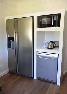 a kitchen with a stainless steel refrigerator and a microwave at Villa au calme et sans vis à vis , proche du village in La Bastide-des-Jourdans