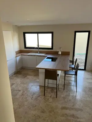 a kitchen with a table and chairs in a room at Villa PERNOISE in Pernes-les-Fontaines